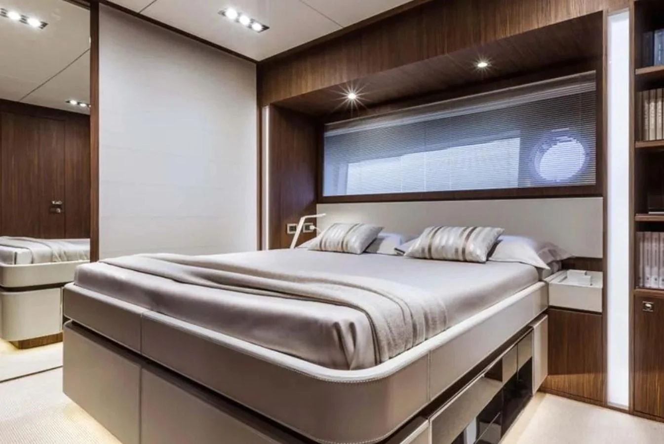 The stateroom features a luxurious bed with modern furnishings and ambient lighting. aboard ANTIOXIDANT Yacht for Sale