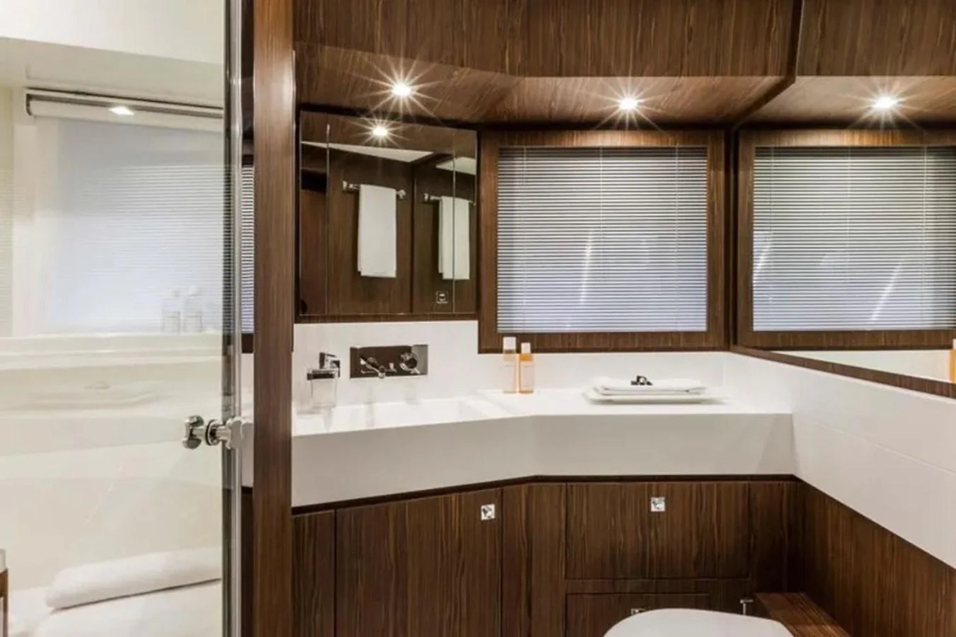 The yacht's bathroom features sleek wood paneling and modern fixtures, creating a luxurious and comfortable space. aboard ANTIOXIDANT Yacht for Sale