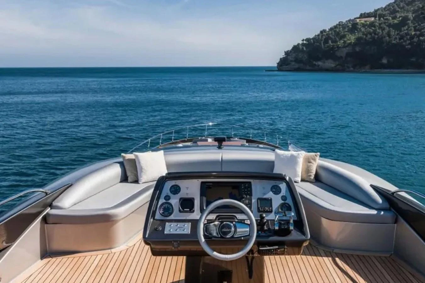 The yacht's helm offers a commanding view of the serene blue waters and distant coastline. aboard ANTIOXIDANT Yacht for Sale