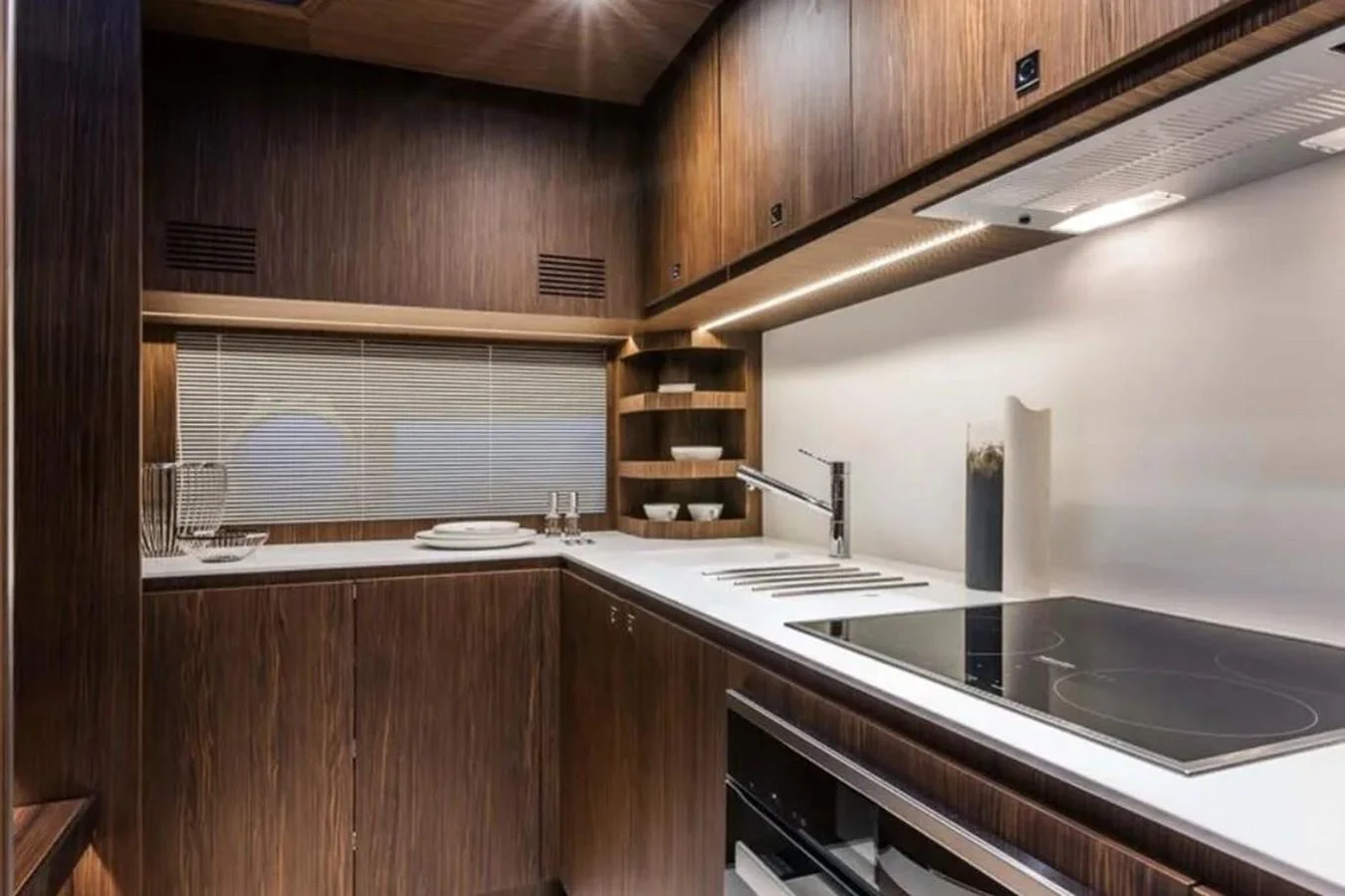 The yacht's galley features sleek wooden cabinetry and modern appliances, creating a stylish and functional space. aboard ANTIOXIDANT Yacht for Sale
