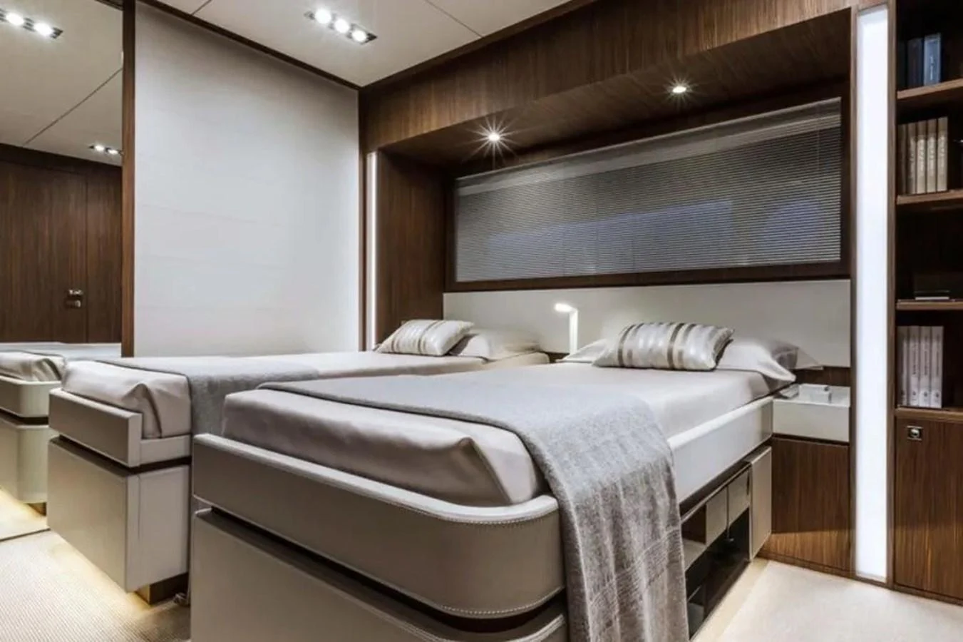 The guest stateroom features twin beds with elegant bedding and modern lighting. aboard ANTIOXIDANT Yacht for Sale