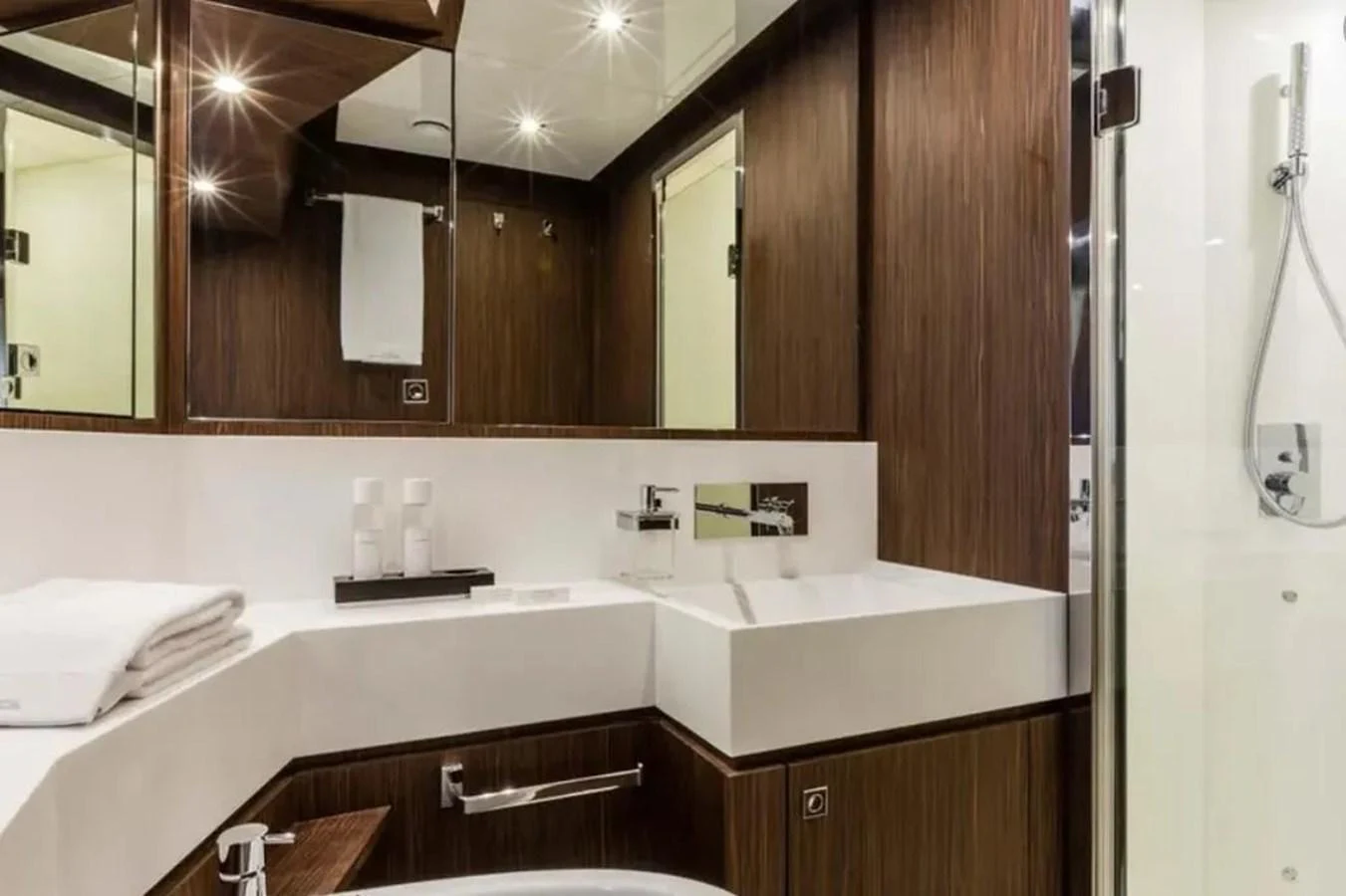 The yacht's bathroom features modern fixtures and elegant wood paneling. aboard ANTIOXIDANT Yacht for Sale