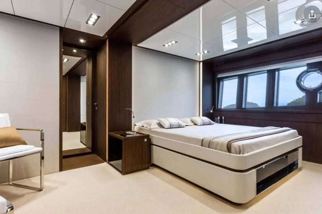 A luxurious stateroom featuring a large bed, modern furnishings, and ample natural light. aboard ANTIOXIDANT Yacht for Sale