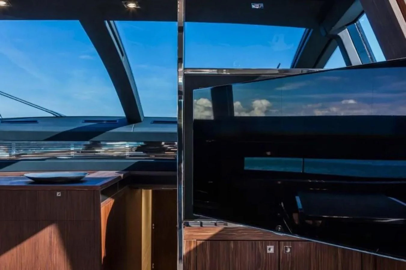 The yacht's salon features modern wood cabinetry and large windows offering stunning views. aboard ANTIOXIDANT Yacht for Sale