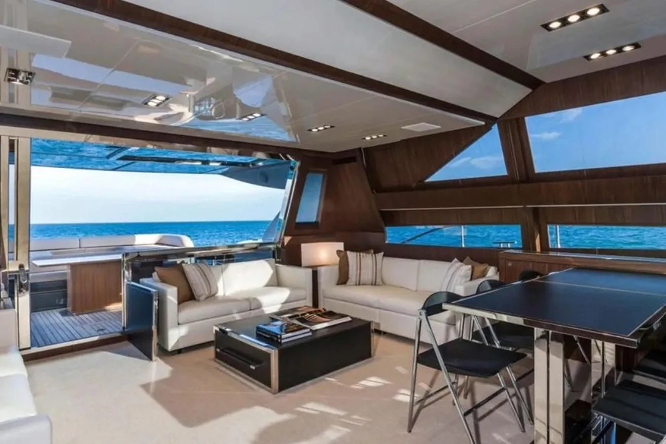 The yacht's salon features luxurious seating with a stunning ocean view. aboard ANTIOXIDANT Yacht for Sale