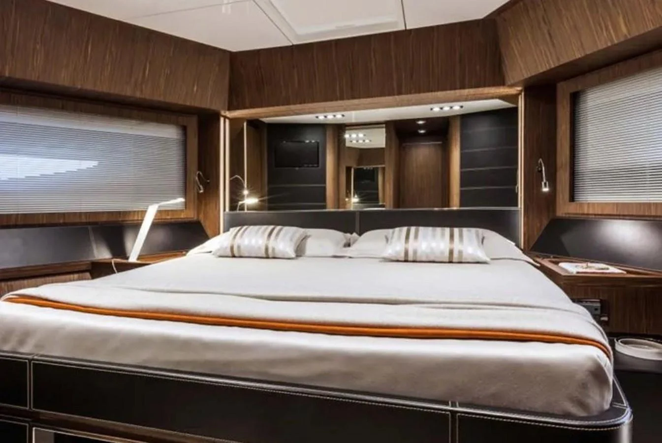 The master stateroom features a luxurious bed with elegant wood paneling and modern lighting. aboard ANTIOXIDANT Yacht for Sale