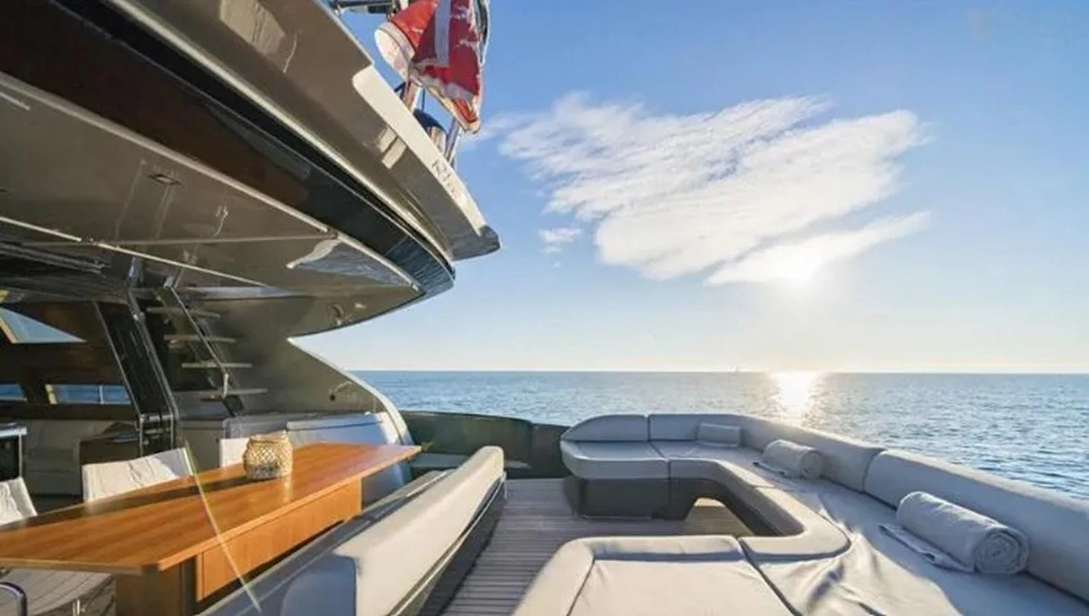 The yacht's aft deck offers a luxurious seating area with stunning ocean views. aboard ANTIOXIDANT Yacht for Sale