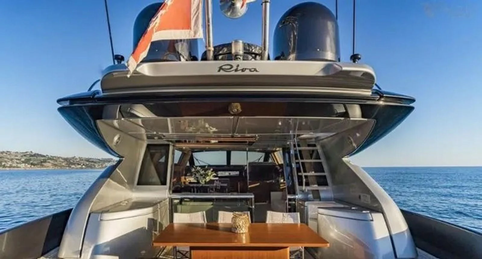 The yacht's aft deck features a stylish dining area with a table and chairs, perfect for alfresco meals. aboard ANTIOXIDANT Yacht for Sale
