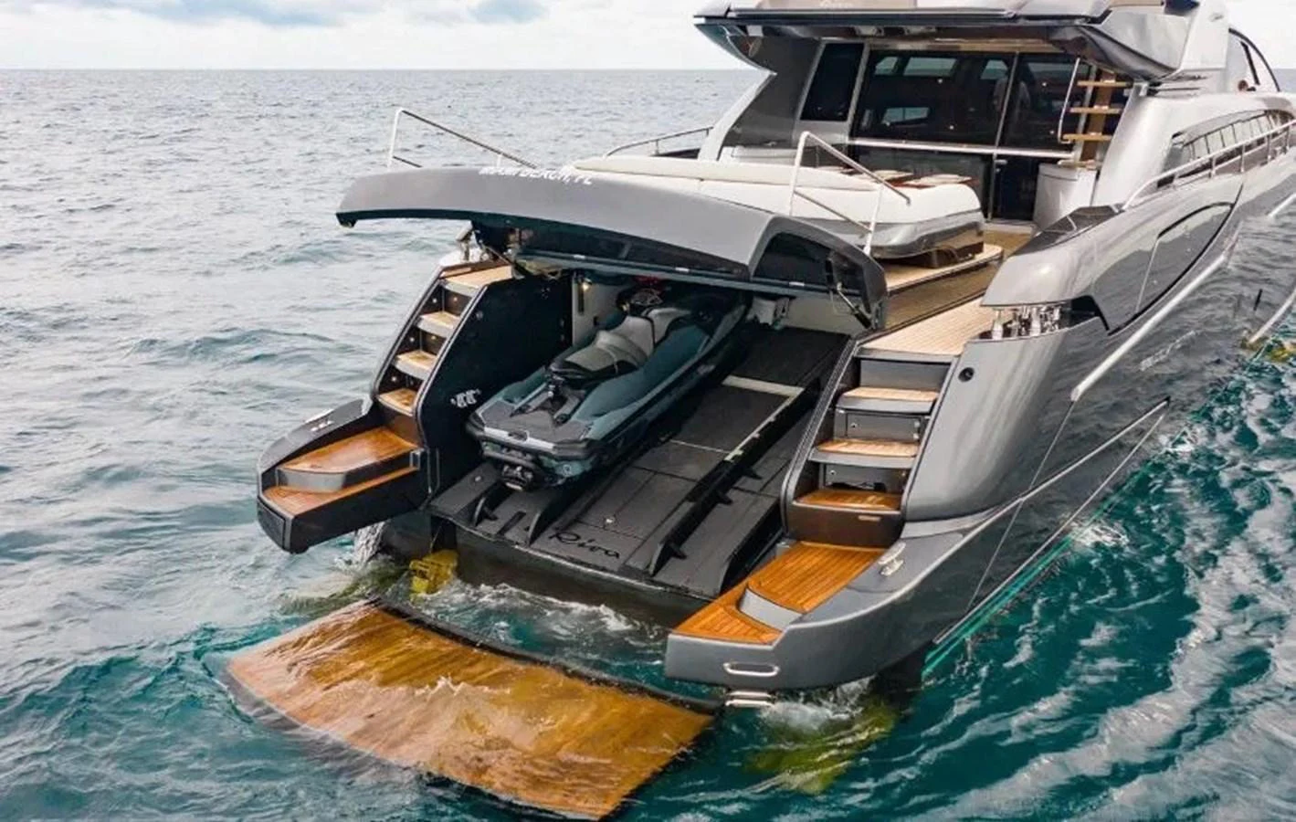 The yacht's aft deck features a sleek garage with a jet ski ready for adventure. aboard ANTIOXIDANT Yacht for Sale