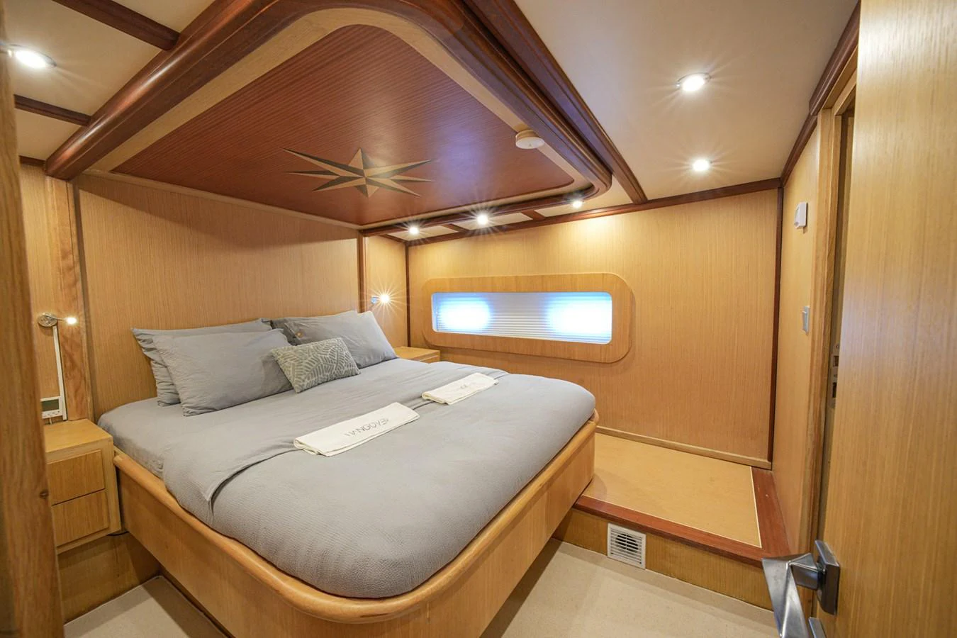 A cozy stateroom with a large bed and ambient lighting. aboard HANGOVER Yacht for Sale