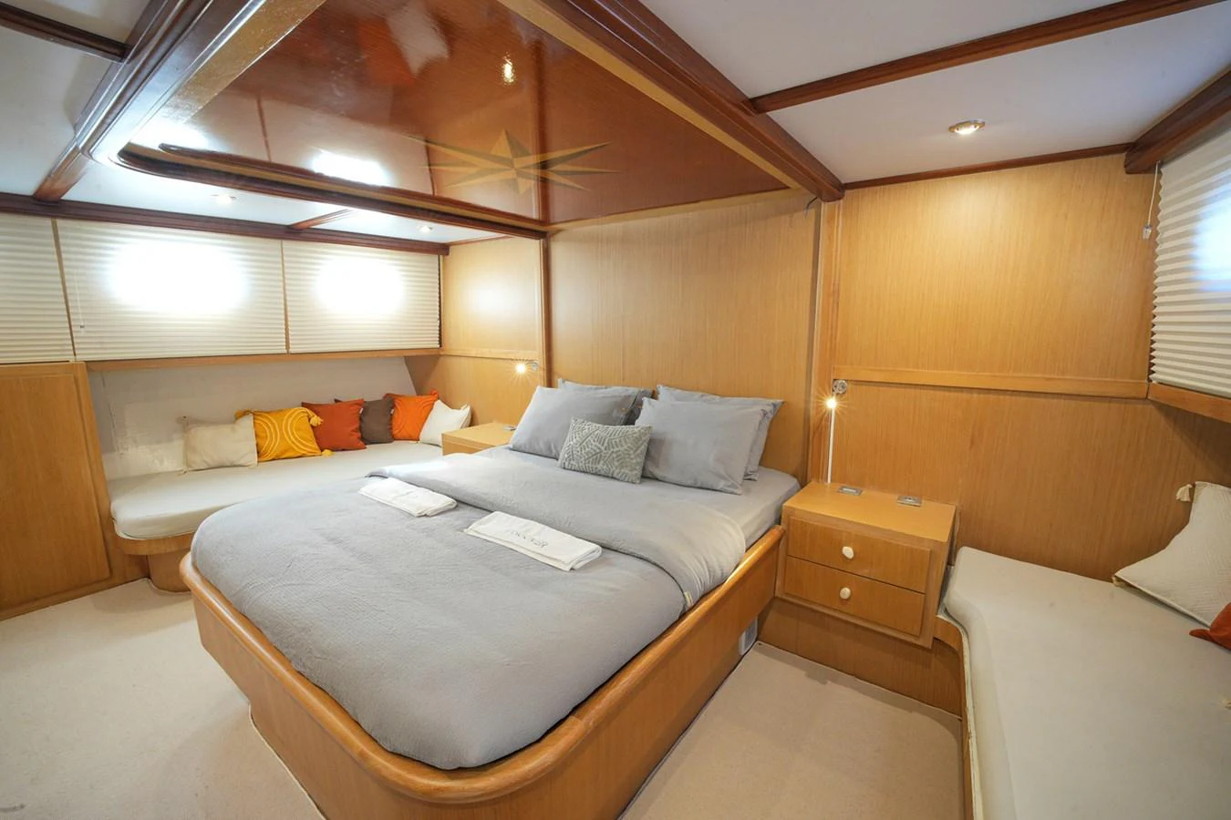 The master stateroom features a spacious bed with elegant bedding and ample natural light. aboard HANGOVER Yacht for Sale