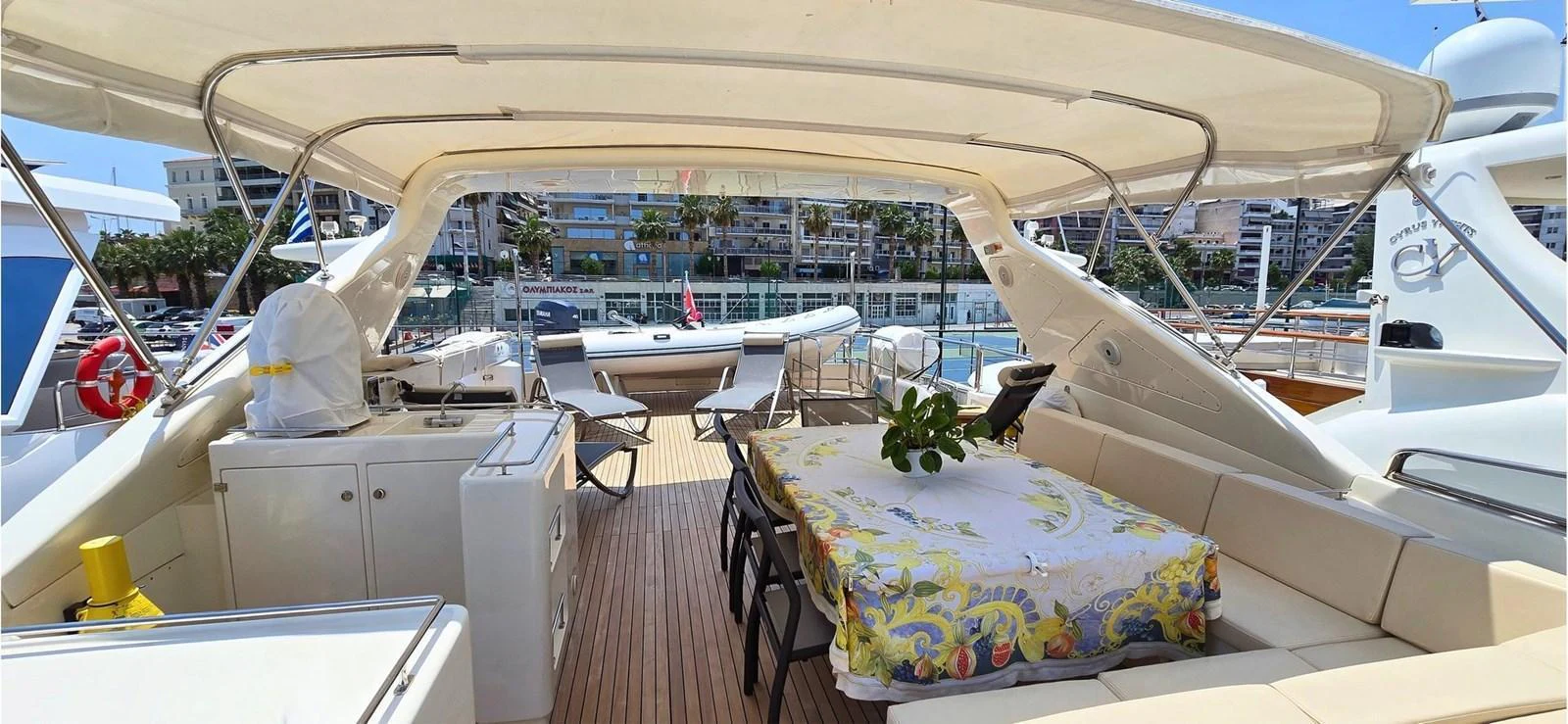 The aft deck offers a spacious and inviting area for dining and relaxation with a view of the marina. aboard BALKAN Yacht for Sale