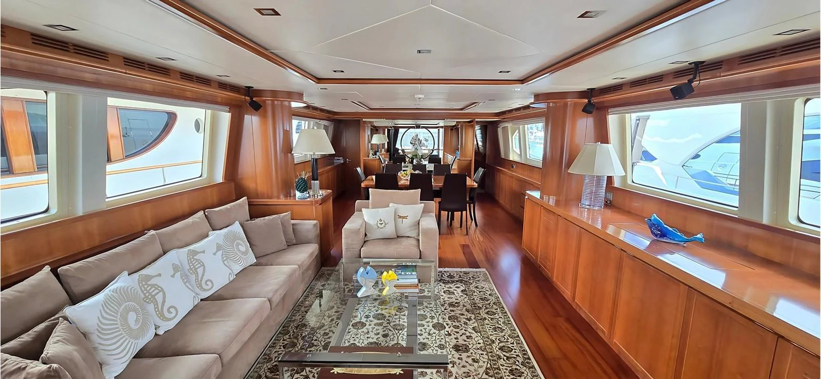 The spacious salon features elegant wood finishes, plush seating, and large windows for natural light. aboard BALKAN Yacht for Sale