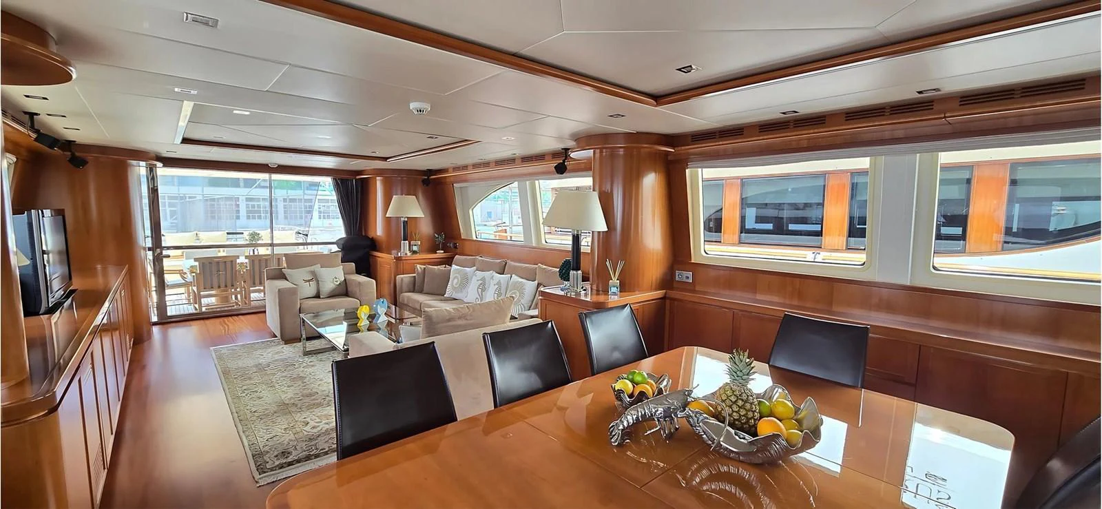 The yacht's salon features a spacious and elegant seating area with large windows providing ample natural light. aboard BALKAN Yacht for Sale
