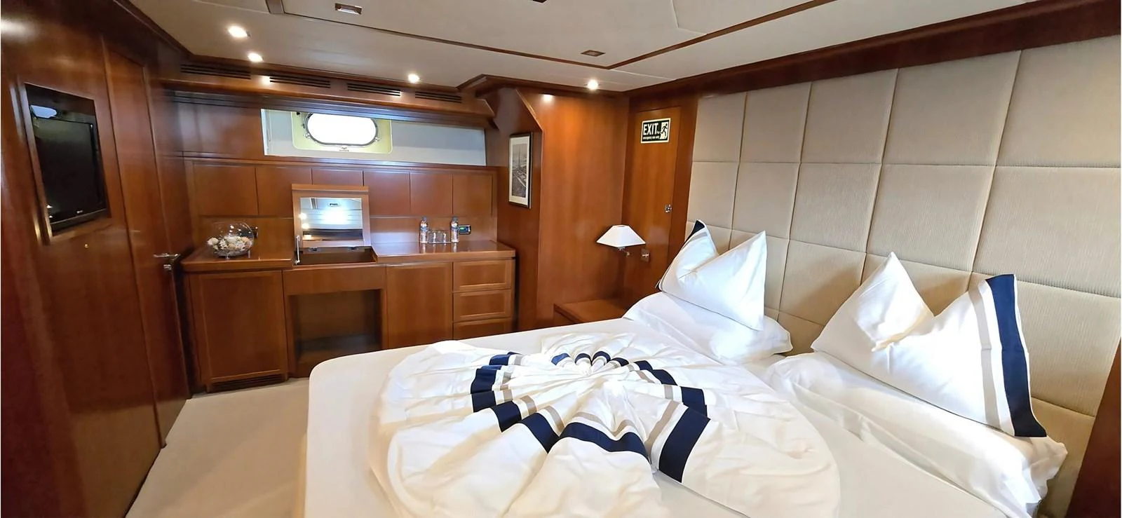 The stateroom features a luxurious bed with elegant linens and ample storage space. aboard BALKAN Yacht for Sale
