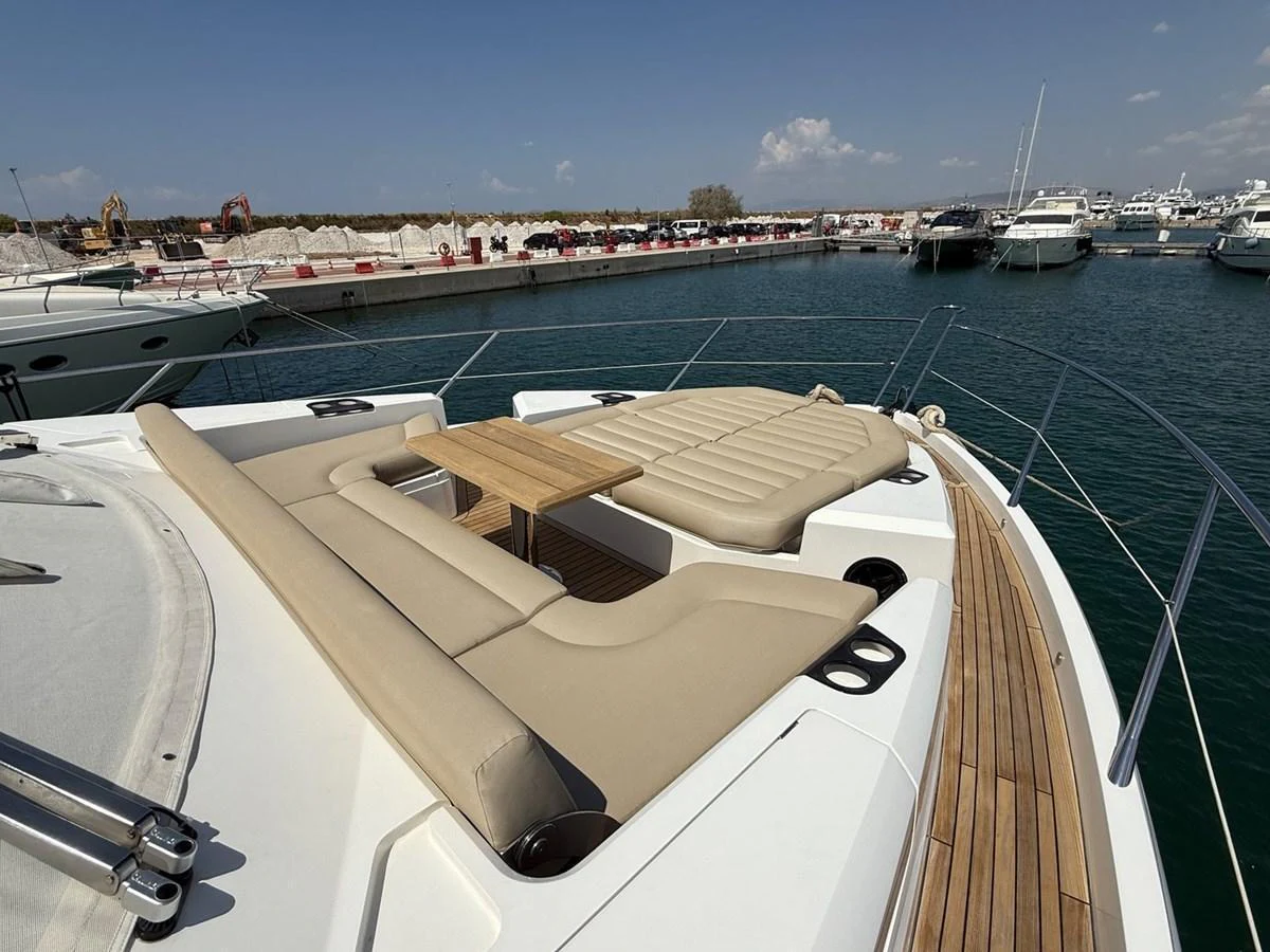 The foredeck features luxurious sun pads and a sleek wooden table, perfect for relaxation and socializing. aboard "BISHWISH" Yacht for Sale