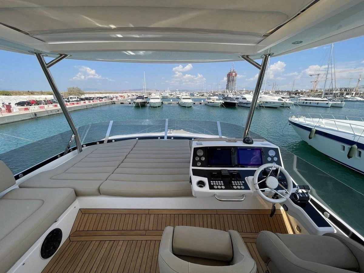 The helm station offers a commanding view of the marina with modern navigation equipment and comfortable seating. aboard "BISHWISH" Yacht for Sale