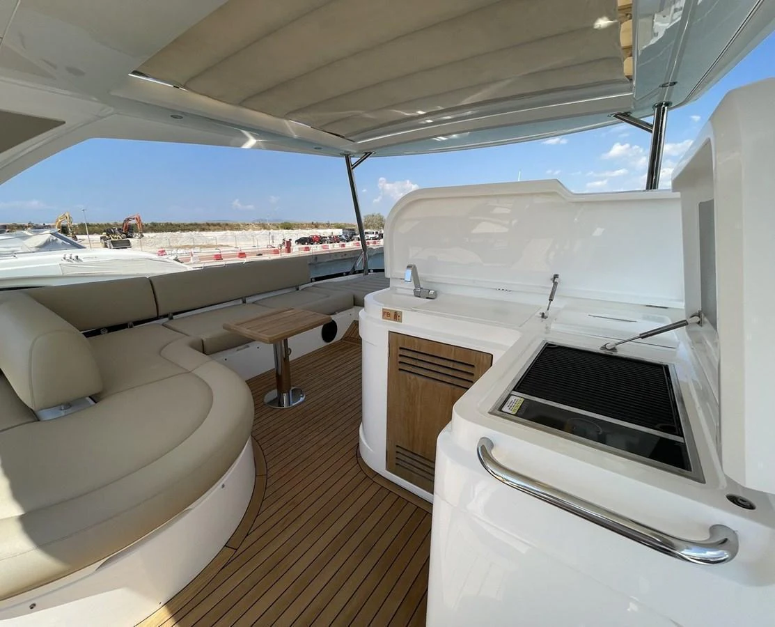 The yacht features a stylish outdoor galley with a grill and comfortable seating area, perfect for alfresco dining. aboard "BISHWISH" Yacht for Sale