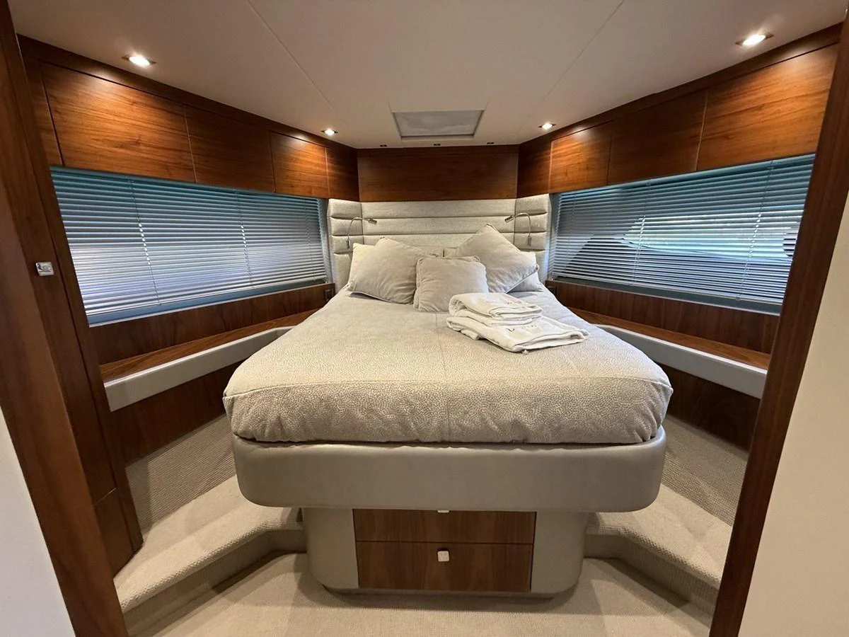 The stateroom features a plush bed with elegant wood paneling and ample natural light. aboard "BISHWISH" Yacht for Sale