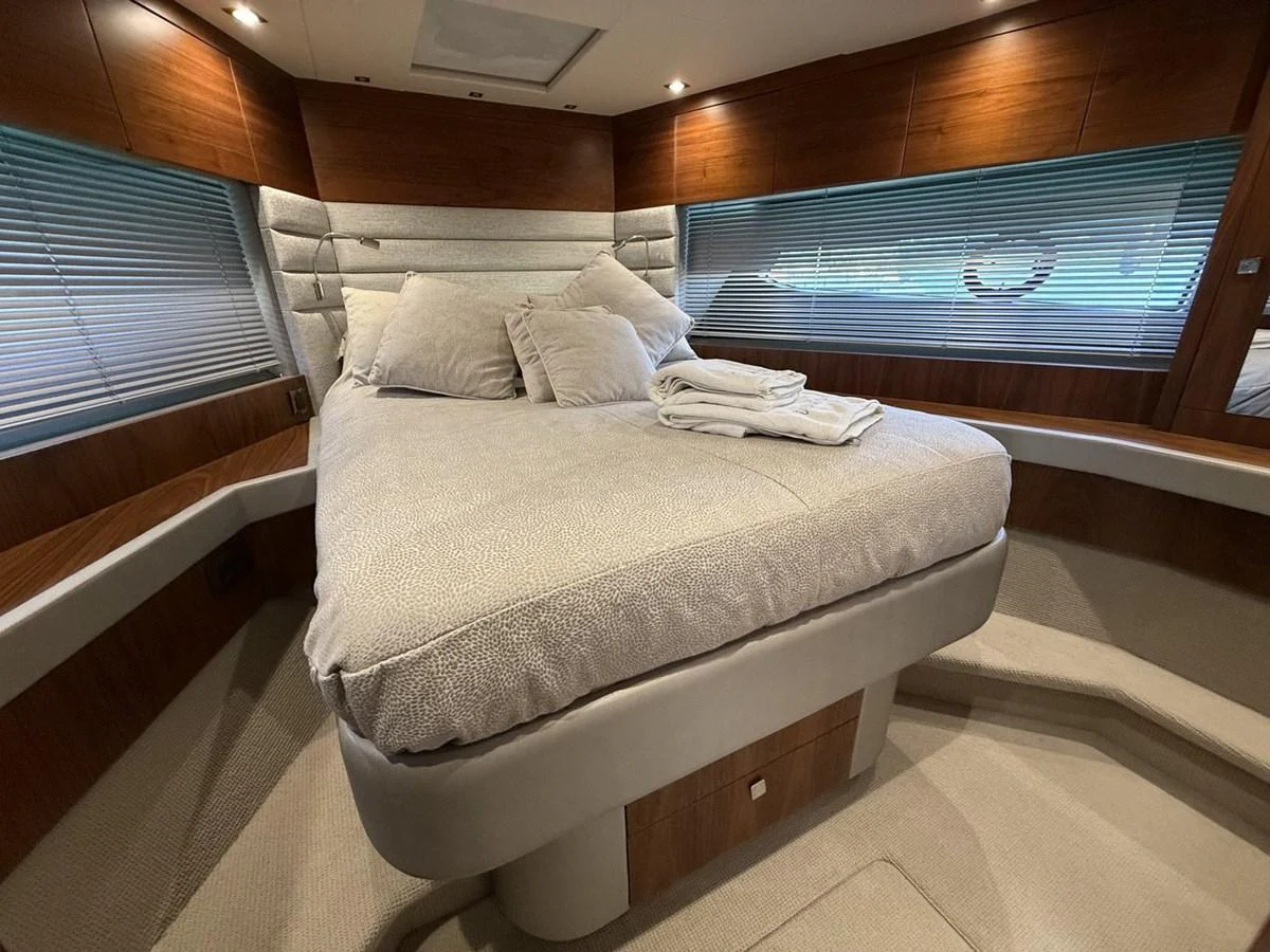 The stateroom features a plush bed with elegant wood paneling and ample natural light. aboard "BISHWISH" Yacht for Sale