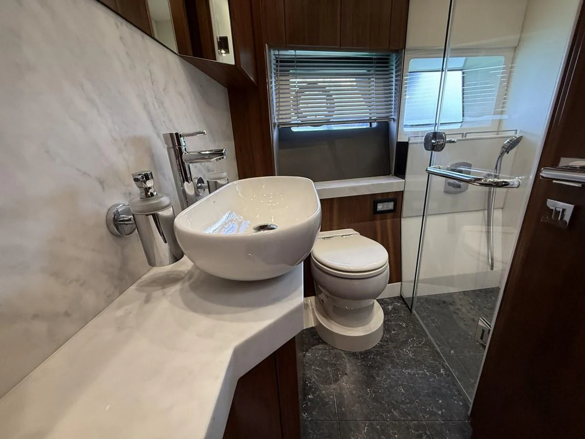The yacht's bathroom features a sleek design with modern fixtures and a glass-enclosed shower. aboard "BISHWISH" Yacht for Sale