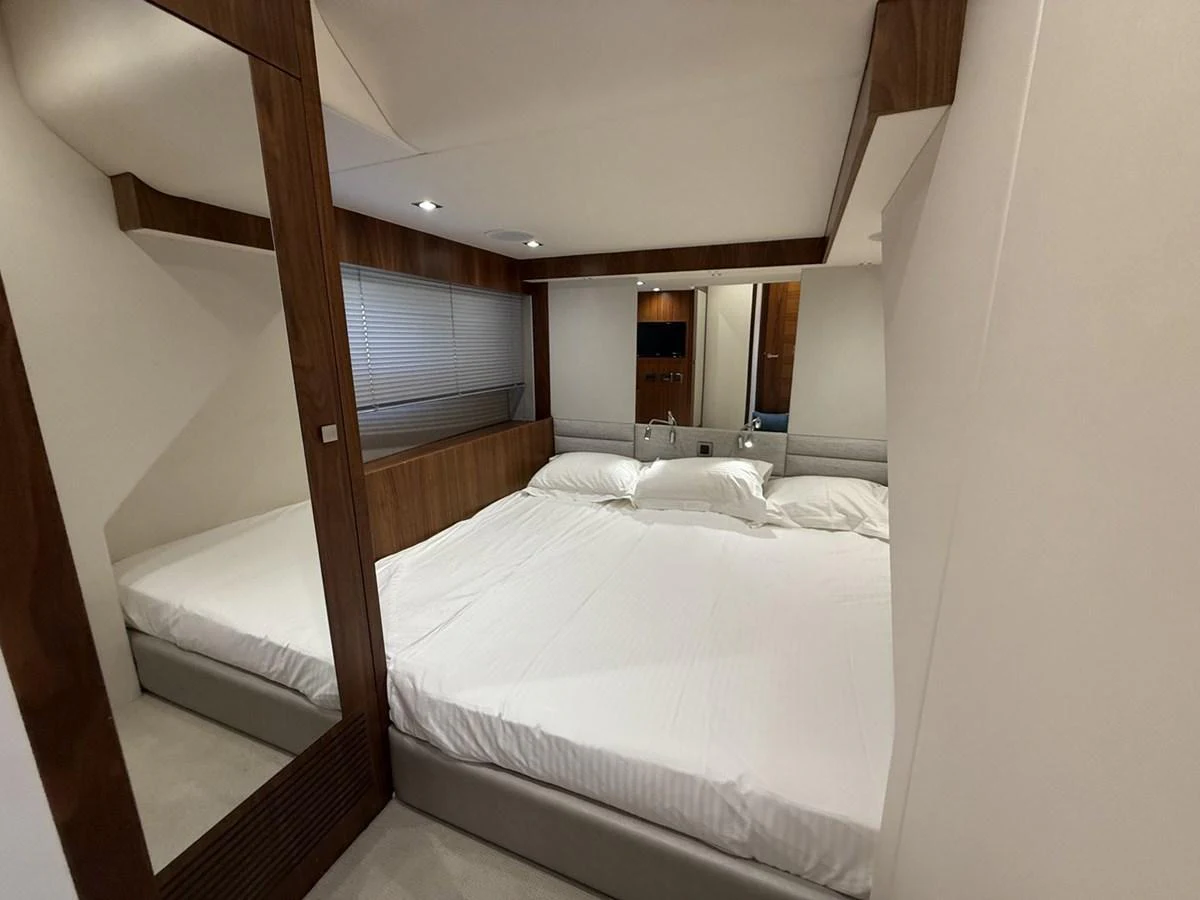 A cozy and well-appointed stateroom with a large bed and modern decor. aboard "BISHWISH" Yacht for Sale
