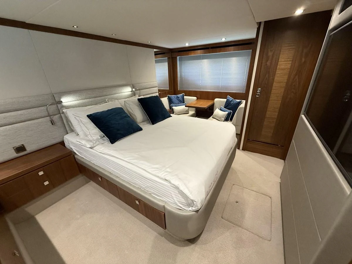 The master stateroom features a spacious bed with plush pillows and elegant wood finishes. aboard "BISHWISH" Yacht for Sale
