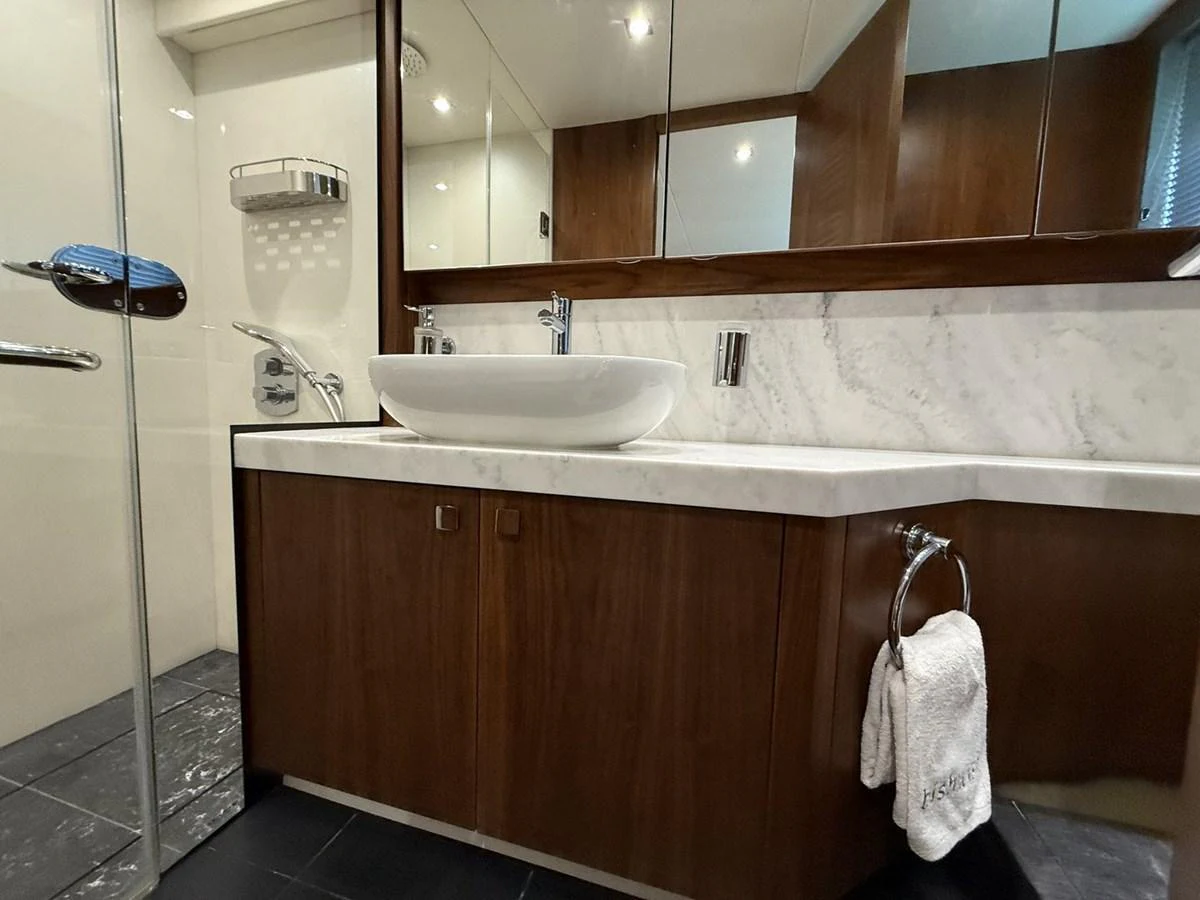 The yacht's bathroom features a sleek design with a modern sink and ample counter space. aboard "BISHWISH" Yacht for Sale