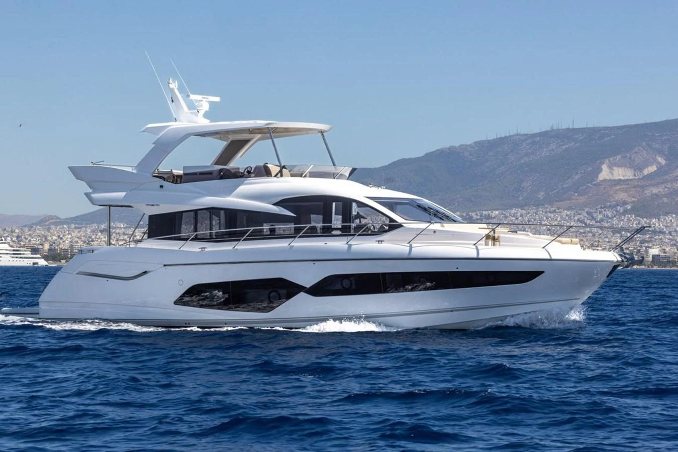 A sleek and modern yacht cruising on the open water with a scenic coastal backdrop. aboard "BISHWISH" Yacht for Sale
