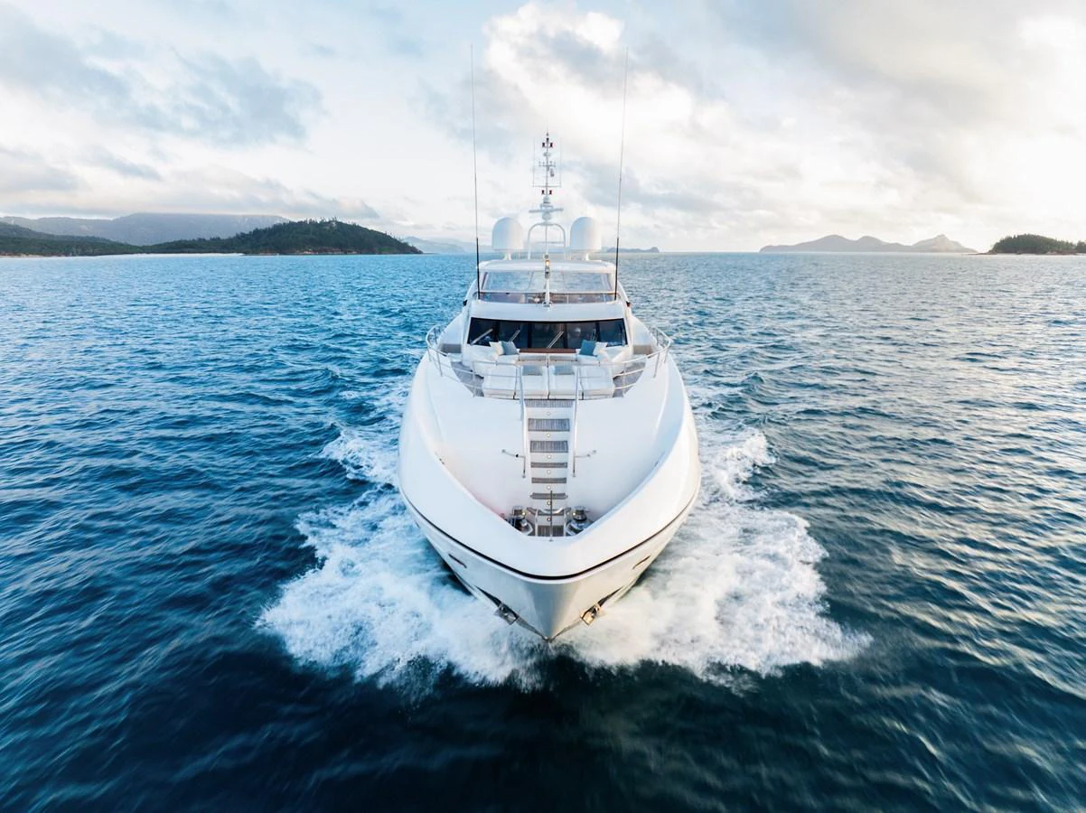 A sleek yacht cruises through open waters, showcasing its impressive bow and modern design. aboard RASCAL Yacht for Sale