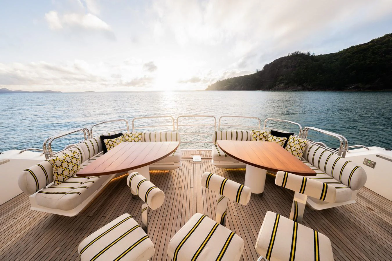 The aft deck features stylish seating with a stunning view of the water and surrounding landscape. aboard RASCAL Yacht for Sale
