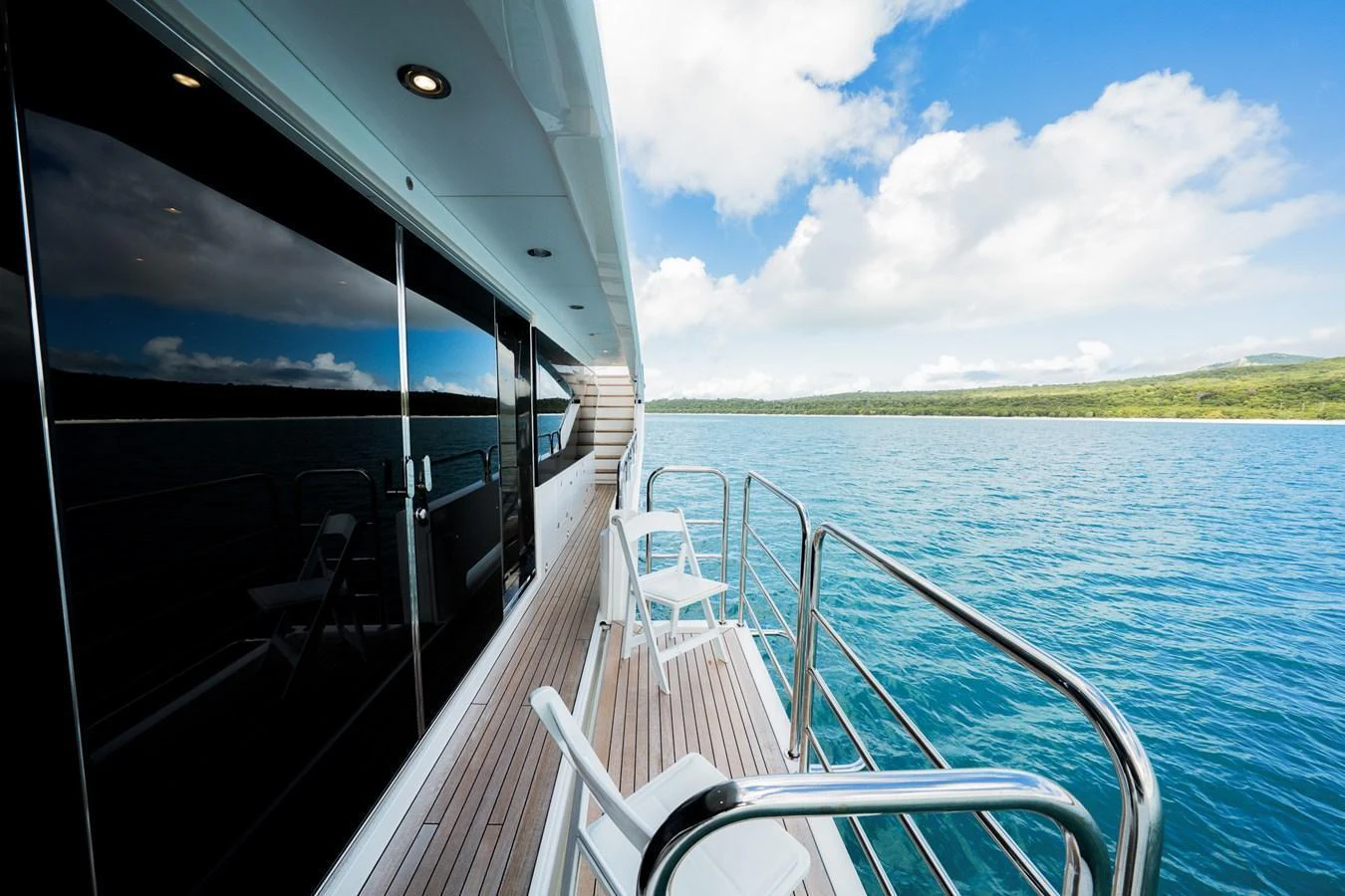 The yacht's side deck offers a serene view of the surrounding waters and landscape. aboard RASCAL Yacht for Sale