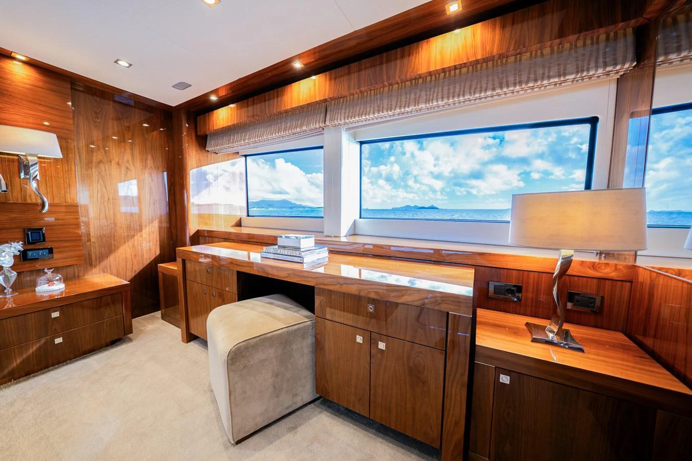 The yacht's office features elegant wood paneling and large windows with stunning ocean views. aboard RASCAL Yacht for Sale