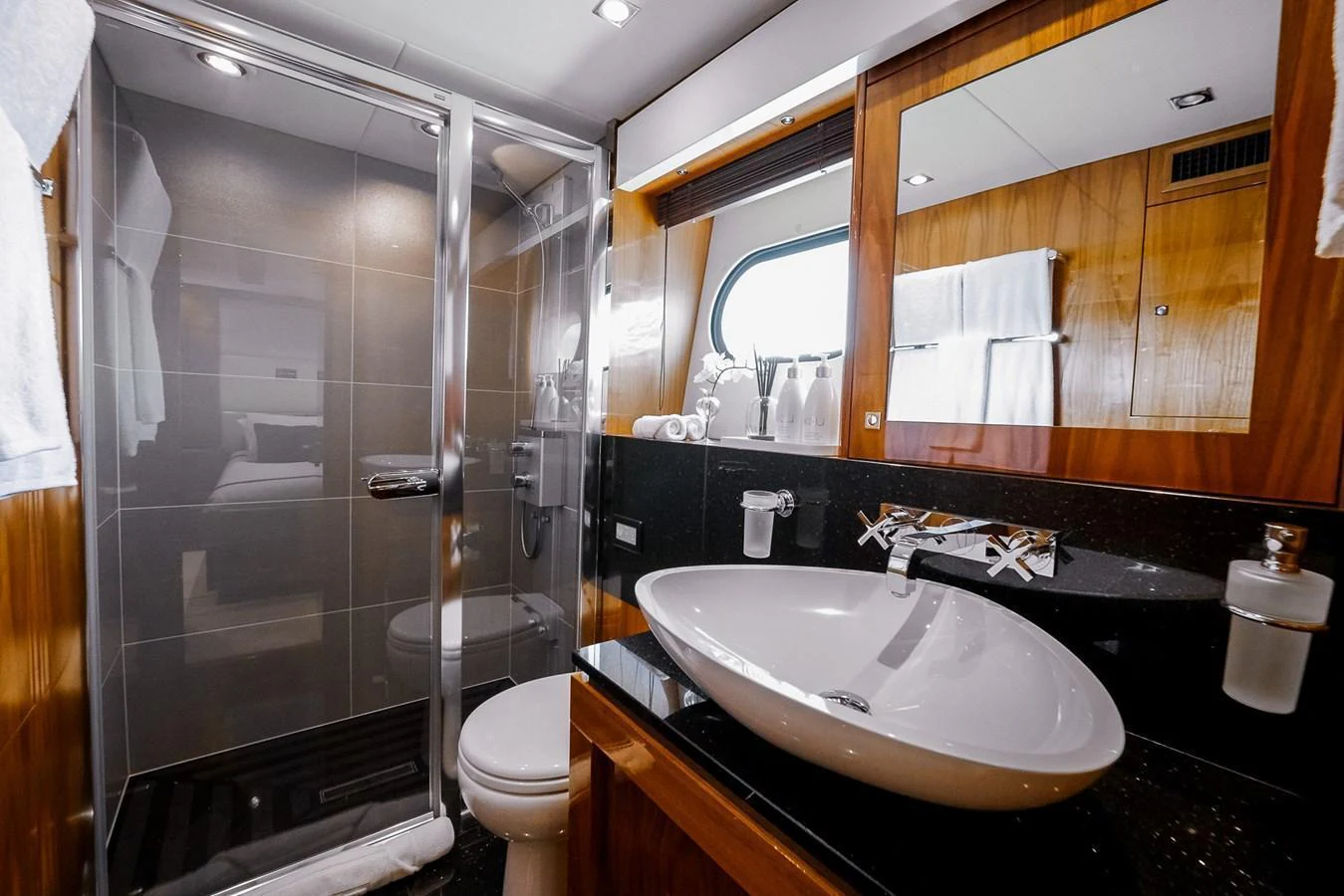 The yacht's bathroom features a sleek design with modern fixtures and ample lighting. aboard RASCAL Yacht for Sale