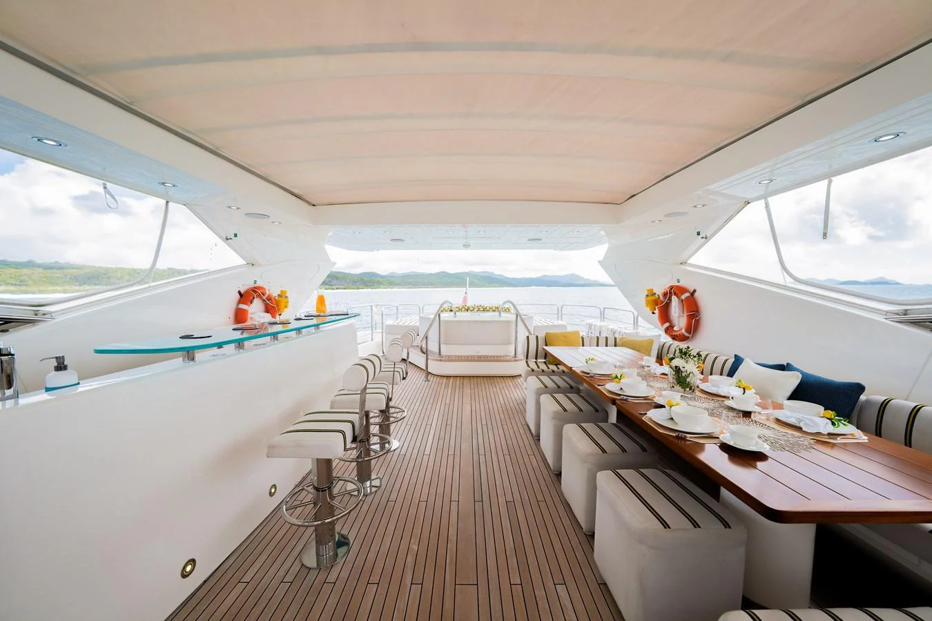 The aft deck features a spacious and elegant dining area with a bar, perfect for entertaining guests while enjoying the sea view. aboard RASCAL Yacht for Sale