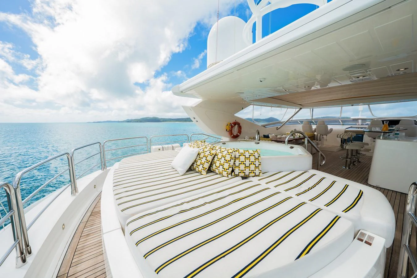 The sundeck offers a luxurious lounging area with plush cushions and a stunning view of the sea. aboard RASCAL Yacht for Sale