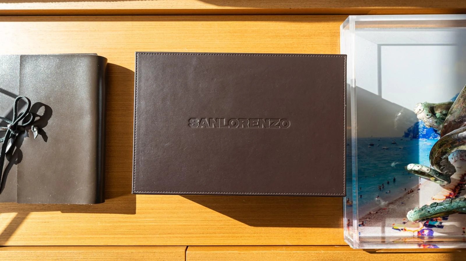 a black rectangular object on a wooden surface aboard SANLORENZO SL120/778 Yacht for Sale