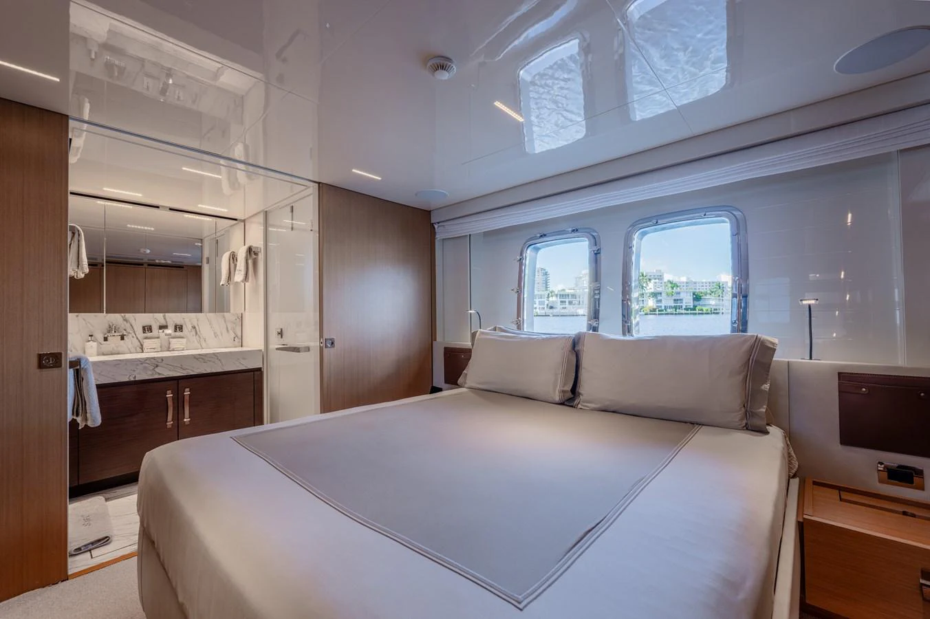 a large white bed in a room aboard SANLORENZO SL120/778 Yacht for Sale