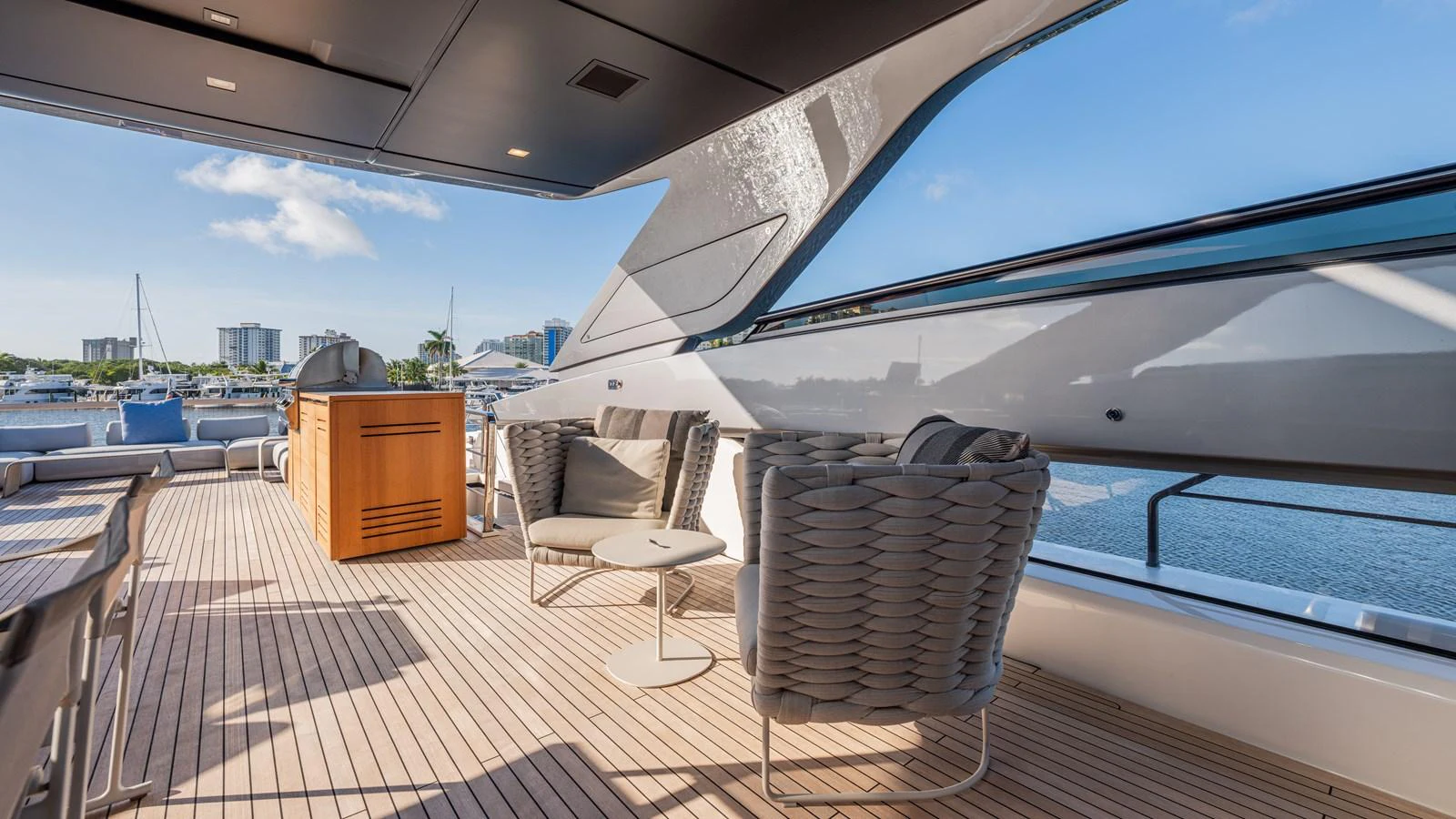 a deck with chairs and a table on it aboard SANLORENZO SL120/778 Yacht for Sale