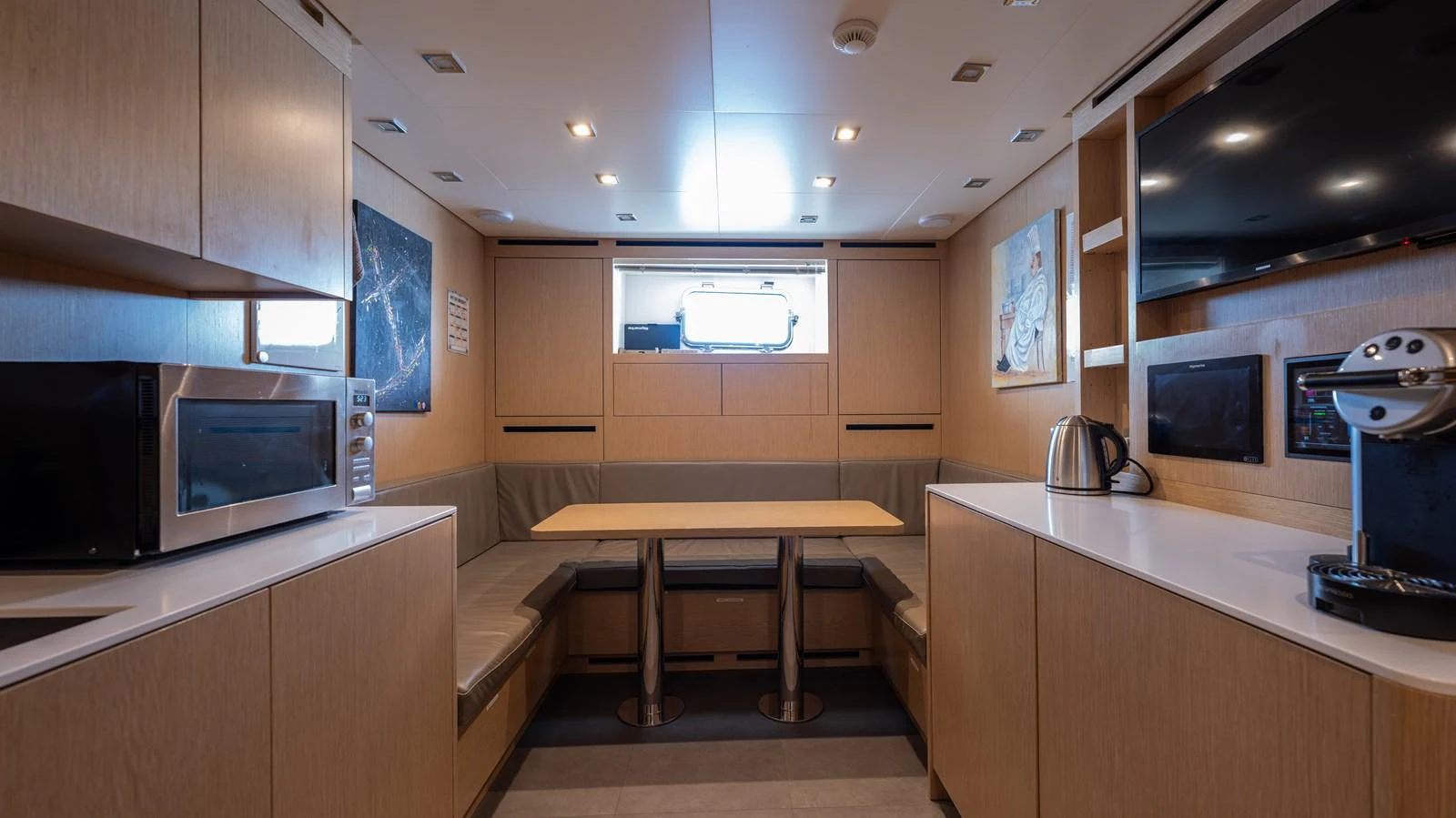 a kitchen with a microwave oven and a table aboard SANLORENZO SL120/778 Yacht for Sale