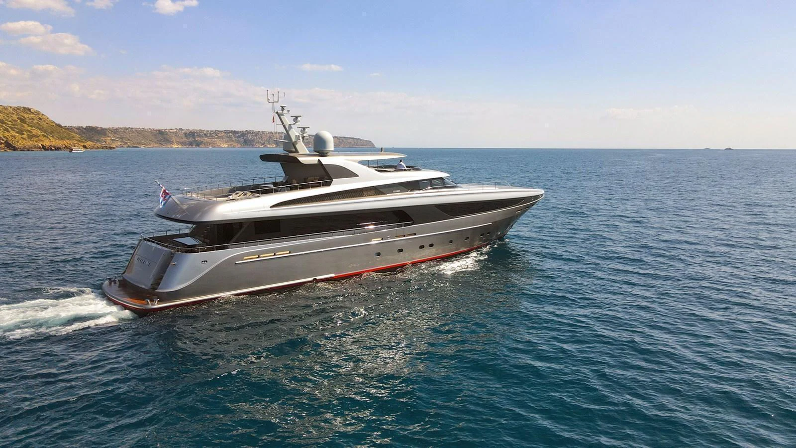 A sleek and modern yacht cruises through calm blue waters under a clear sky. aboard SMOOTH OPERATOR Yacht for Sale