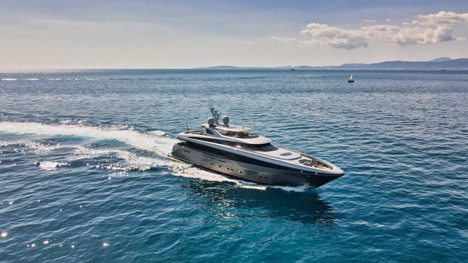 A sleek yacht cruises through calm blue waters under a clear sky. aboard SMOOTH OPERATOR Yacht for Sale