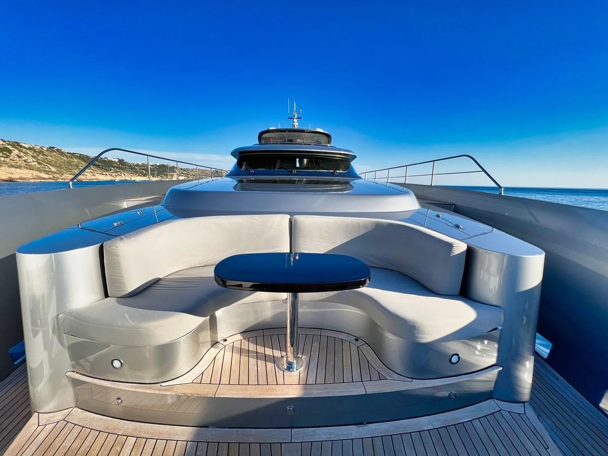 The foredeck features a stylish seating area with a sleek table, perfect for enjoying the ocean views. aboard SMOOTH OPERATOR Yacht for Sale