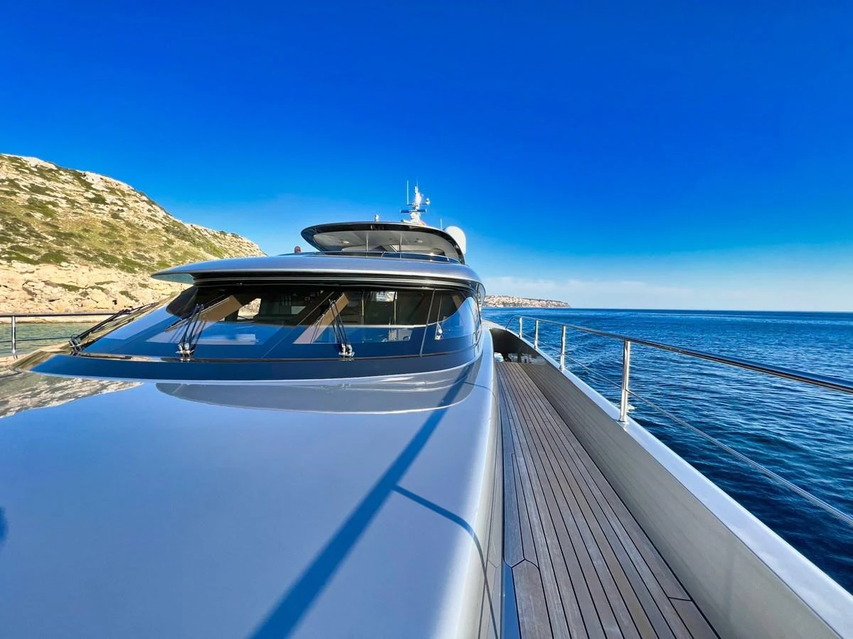 The sleek exterior of the yacht is showcased against a stunning coastal backdrop. aboard SMOOTH OPERATOR Yacht for Sale