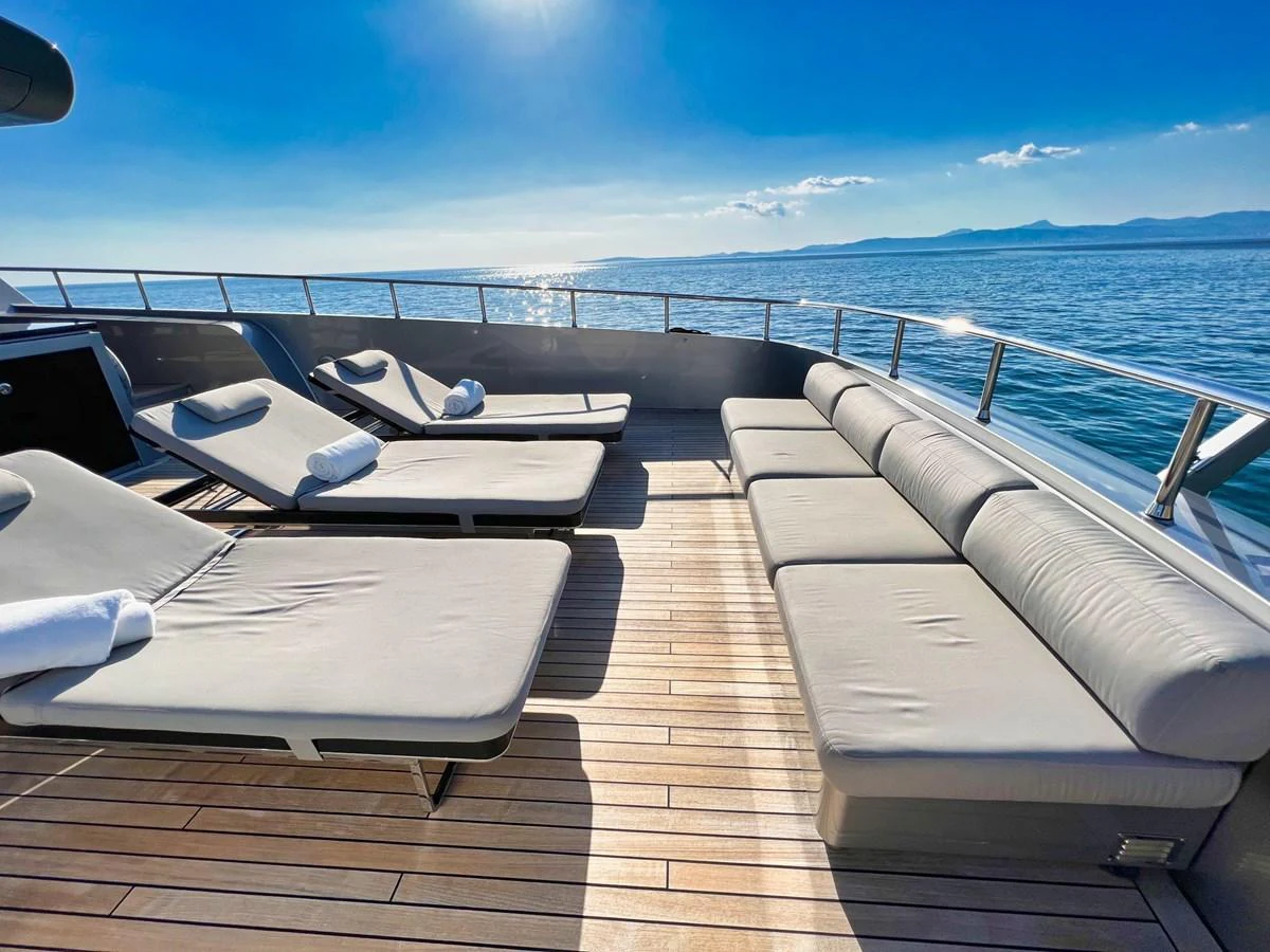 The sundeck offers luxurious lounging with plush sunbeds and a stunning ocean view. aboard SMOOTH OPERATOR Yacht for Sale