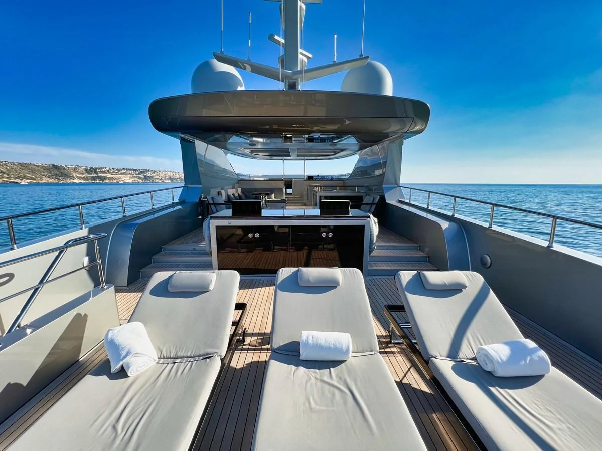 The sundeck offers a luxurious space for relaxation with sun loungers and a stunning ocean view. aboard SMOOTH OPERATOR Yacht for Sale