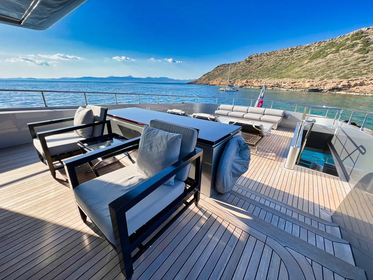 The aft deck offers a luxurious outdoor seating area with stunning views of the surrounding waters. aboard SMOOTH OPERATOR Yacht for Sale