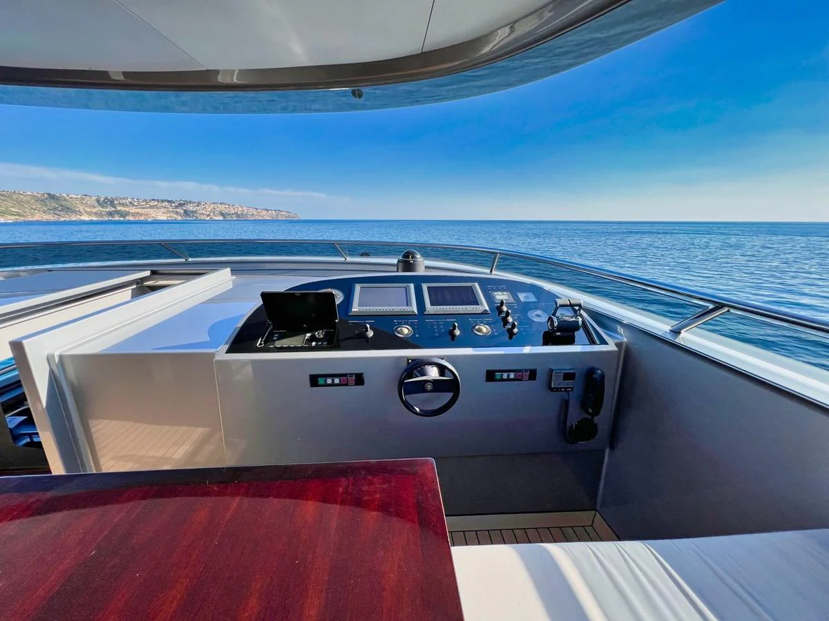 The yacht's helm offers a commanding view of the open sea, equipped with modern navigation instruments. aboard SMOOTH OPERATOR Yacht for Sale