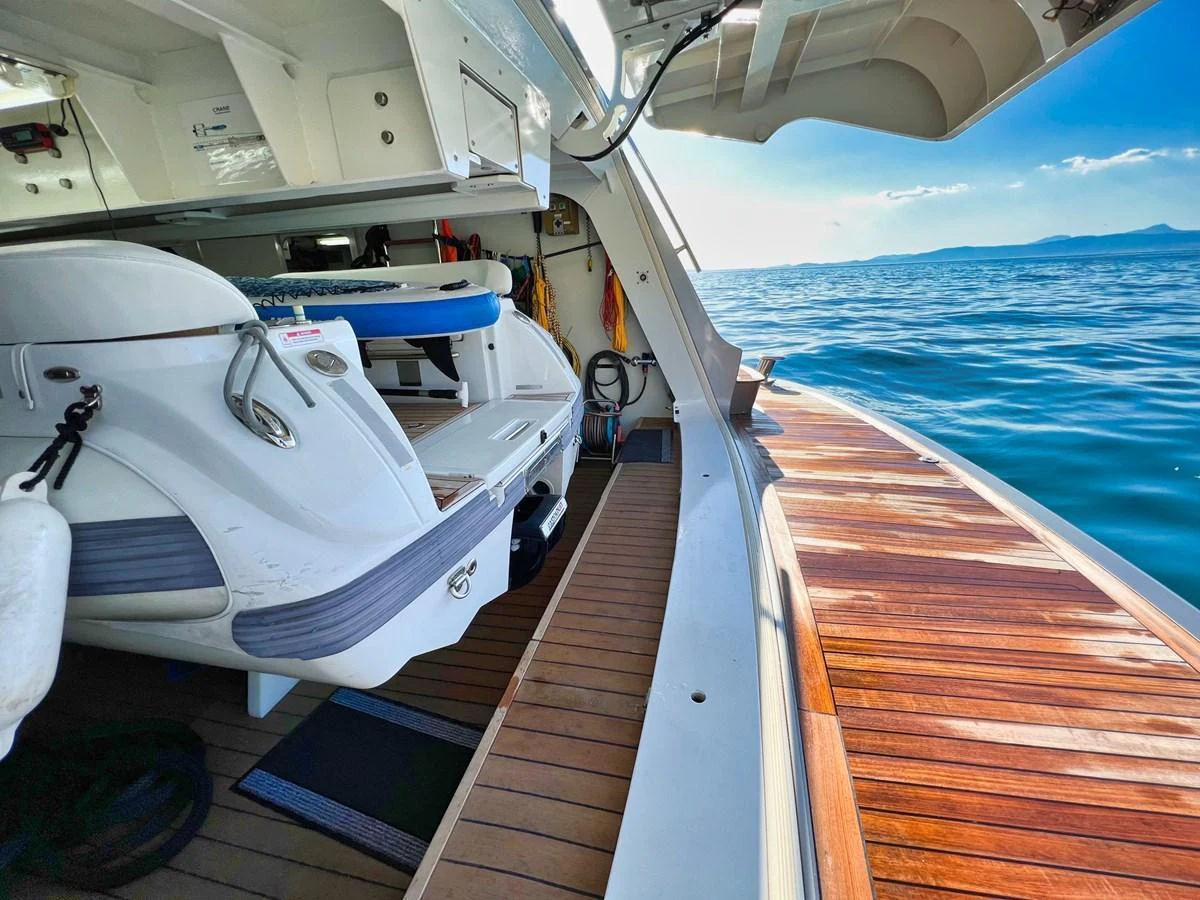 The image showcases a detailed view of the yacht's swim platform and storage area, with the ocean in the background. aboard SMOOTH OPERATOR Yacht for Sale
