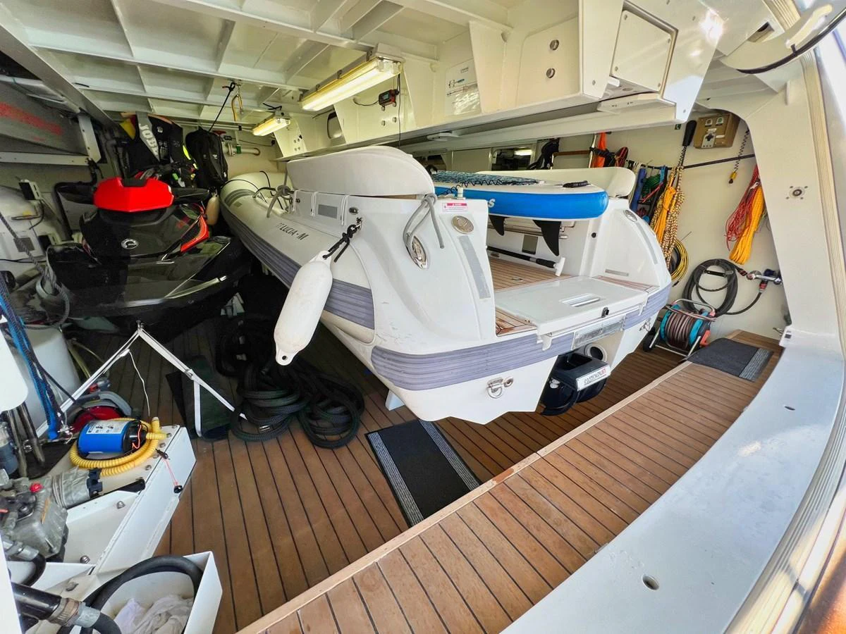 The yacht's tender garage is equipped with a well-maintained tender and various water sports equipment. aboard SMOOTH OPERATOR Yacht for Sale